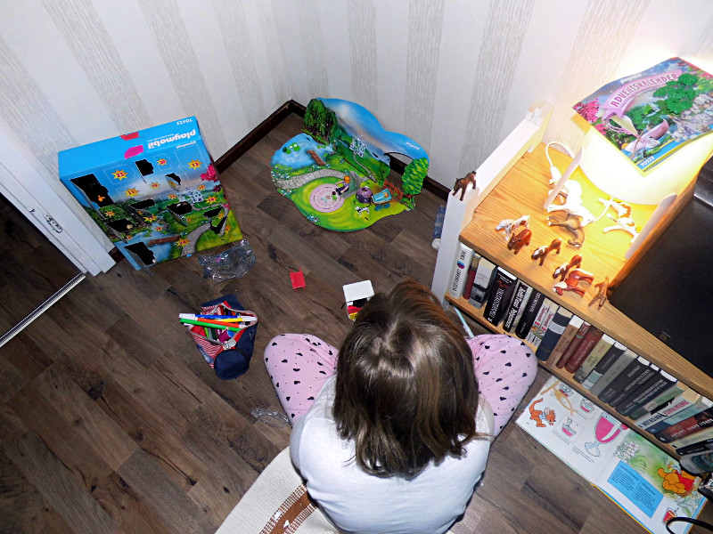 Julie joue avec ses playmobils à l'appartement