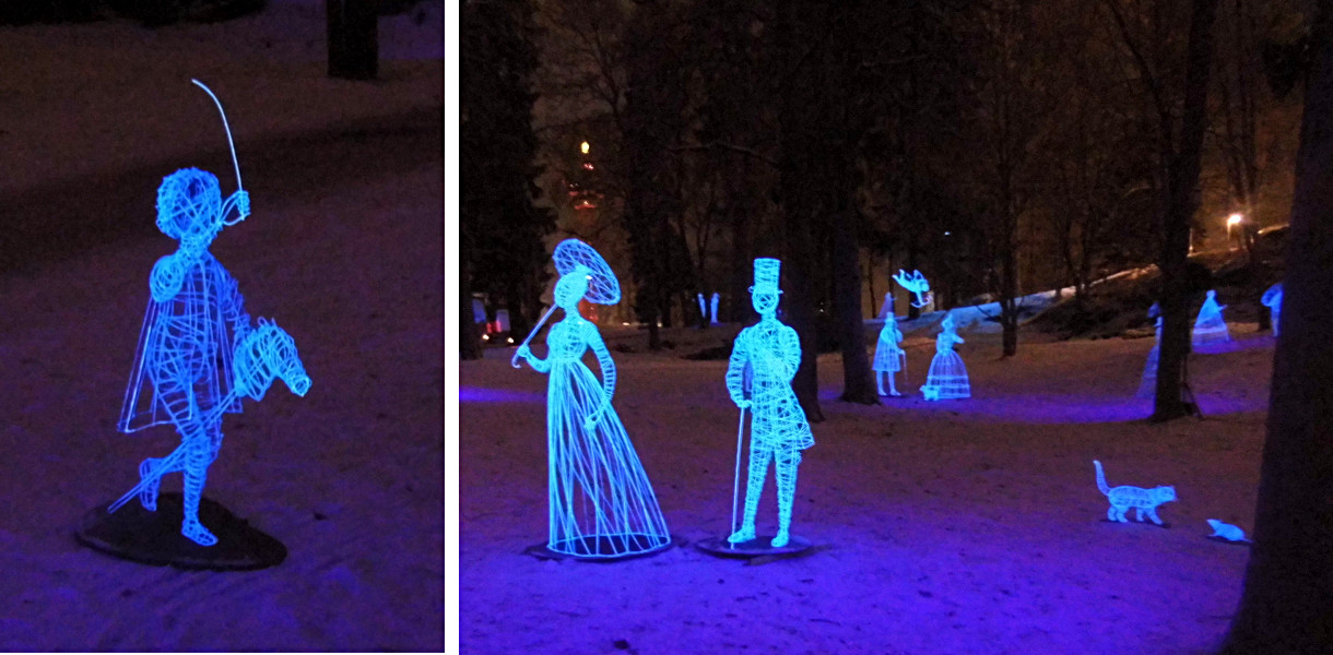 Les sculptures éclairées dans Nasinpuisto - couple, chat avec souris et enfant jouant